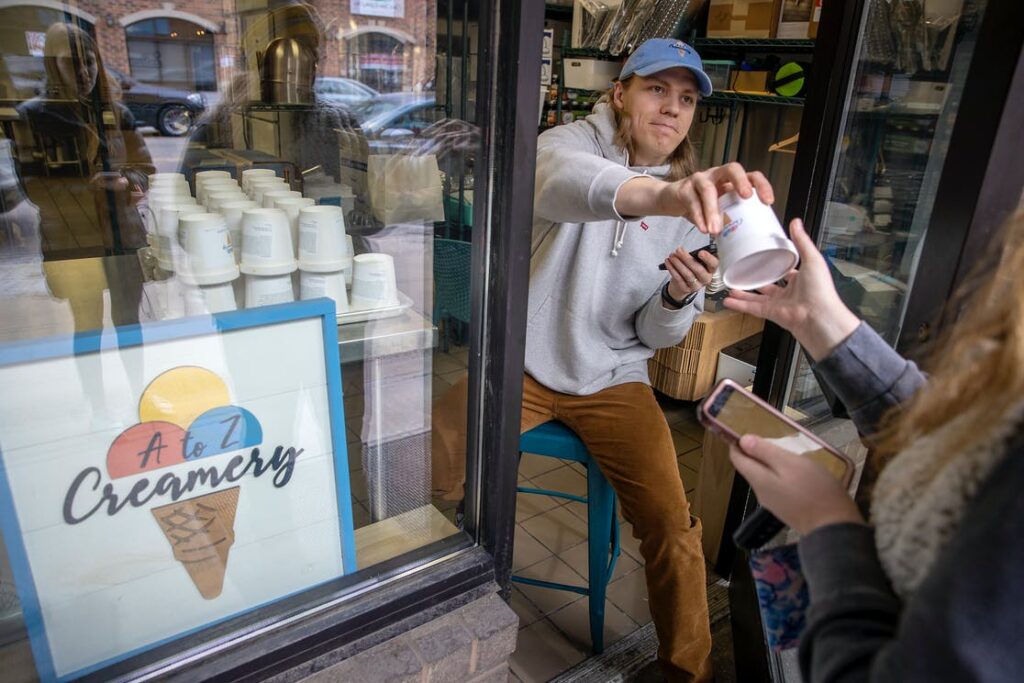 Pints of ice cream being handed out to lottery winners at A to Z Creamery in Hopkins, MN.
