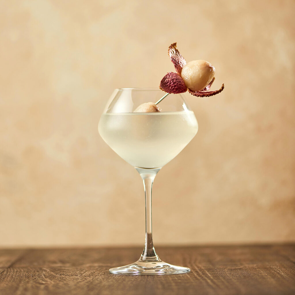 a lychee martini with a garnish